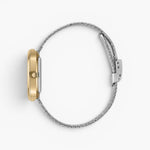 JONES + CO Jane Tethered watch with a gold oval case and silver woven mesh bracelet, side profile view.