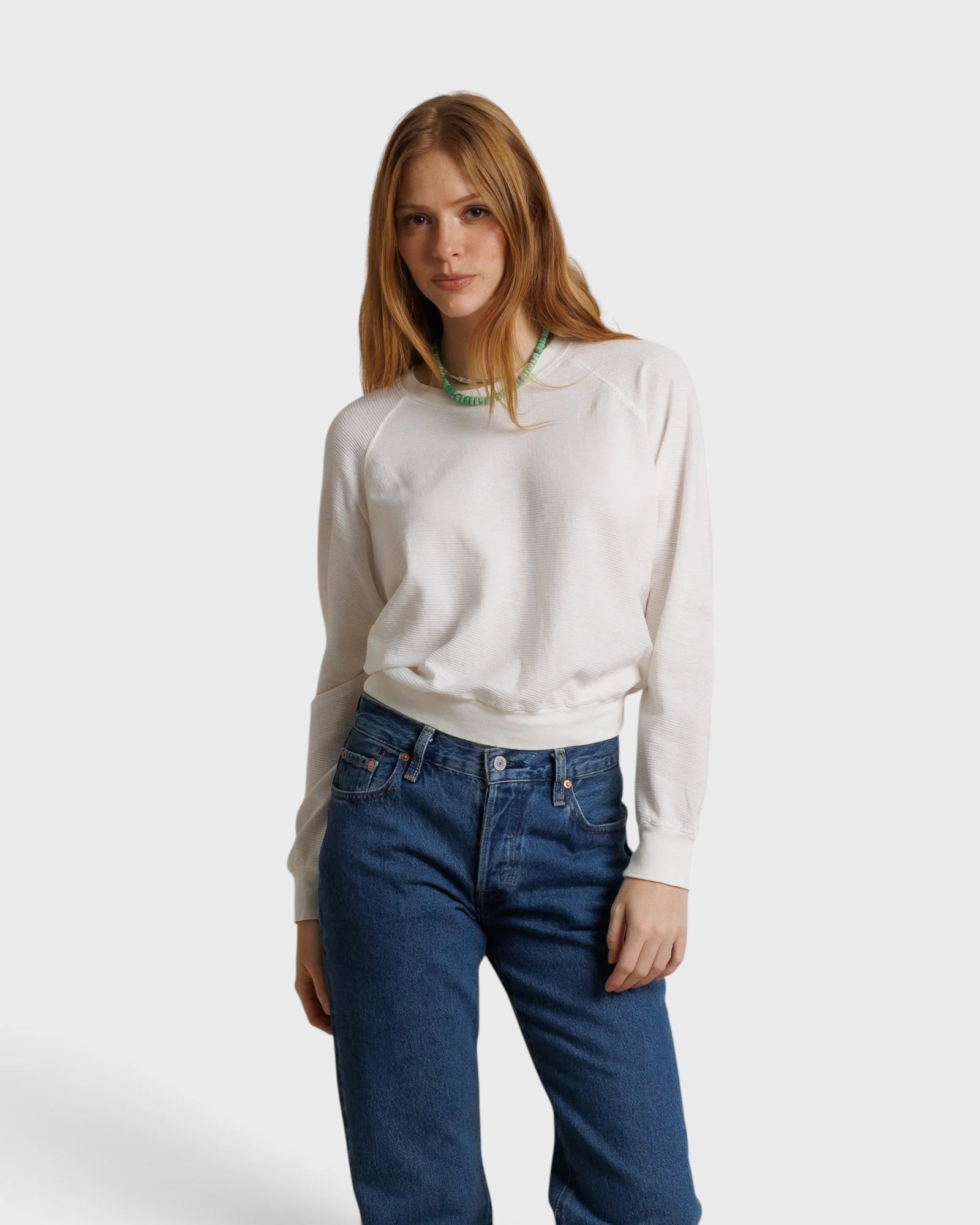 JONES + CO Jasper textured jersey crew neck sweater in natural white worn by a model with blue jeans