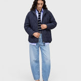JONES + CO Jazzie barrel jeans in light blue denim with a relaxed cropped fit worn by a model in a quilted jacket.
