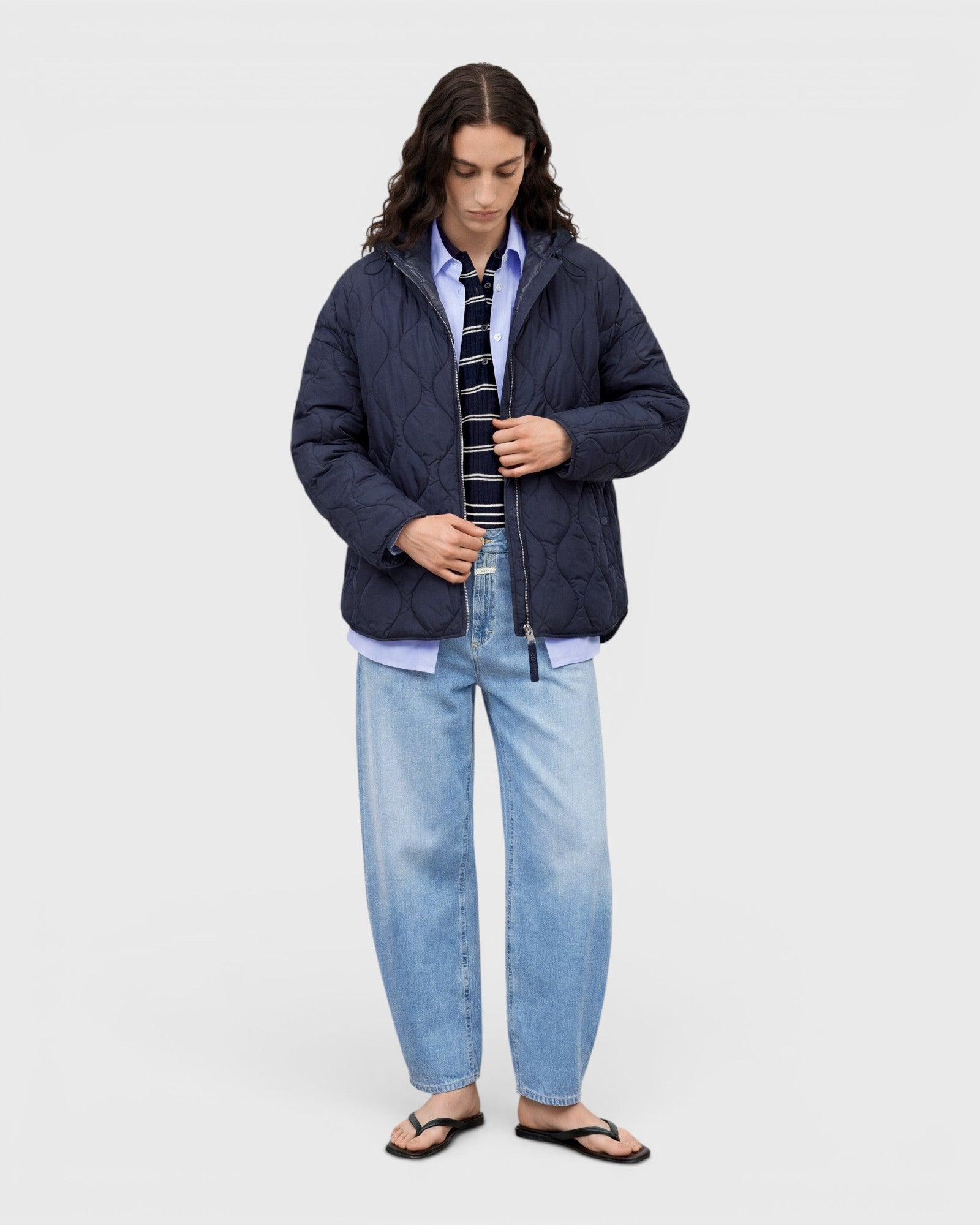 JONES + CO Jazzie barrel jeans in light blue denim with a relaxed cropped fit worn by a model in a quilted jacket.