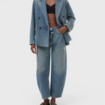 JONES + CO Jazzie barrel jeans in distressed blue denim with a matching denim blazer on a model