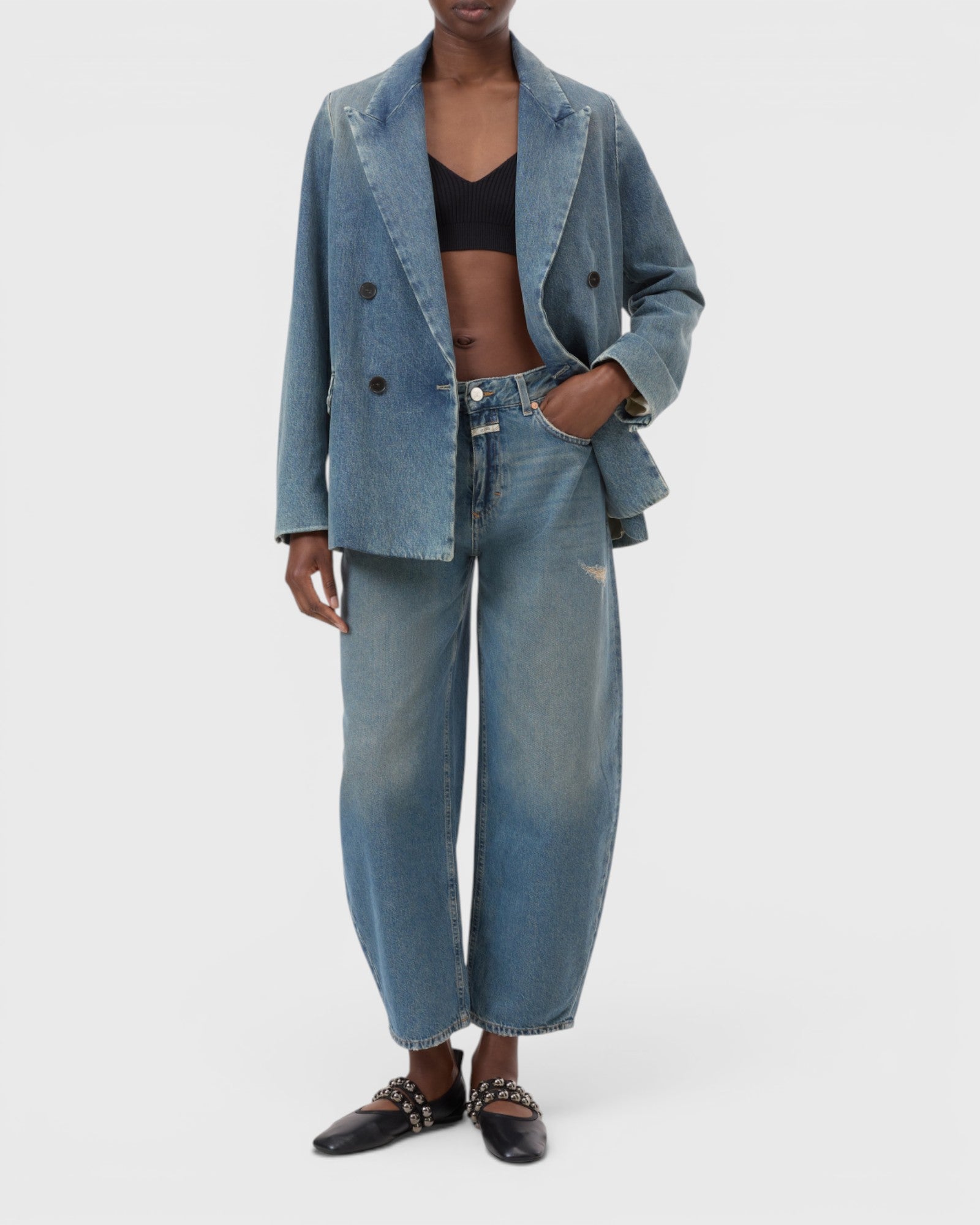 JONES + CO Jazzie barrel jeans in distressed blue denim with a matching denim blazer on a model