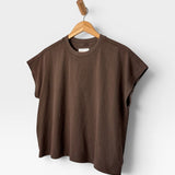 JONES + CO Jeanne muscle tee in chocolate brown with a high crew neck and dolman sleeves hanging on a wooden hanger.