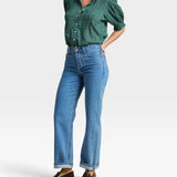 JONES + CO Jess Blouse in green Muir Tartan with short puff sleeves, pintuck details, and a curved hemline.