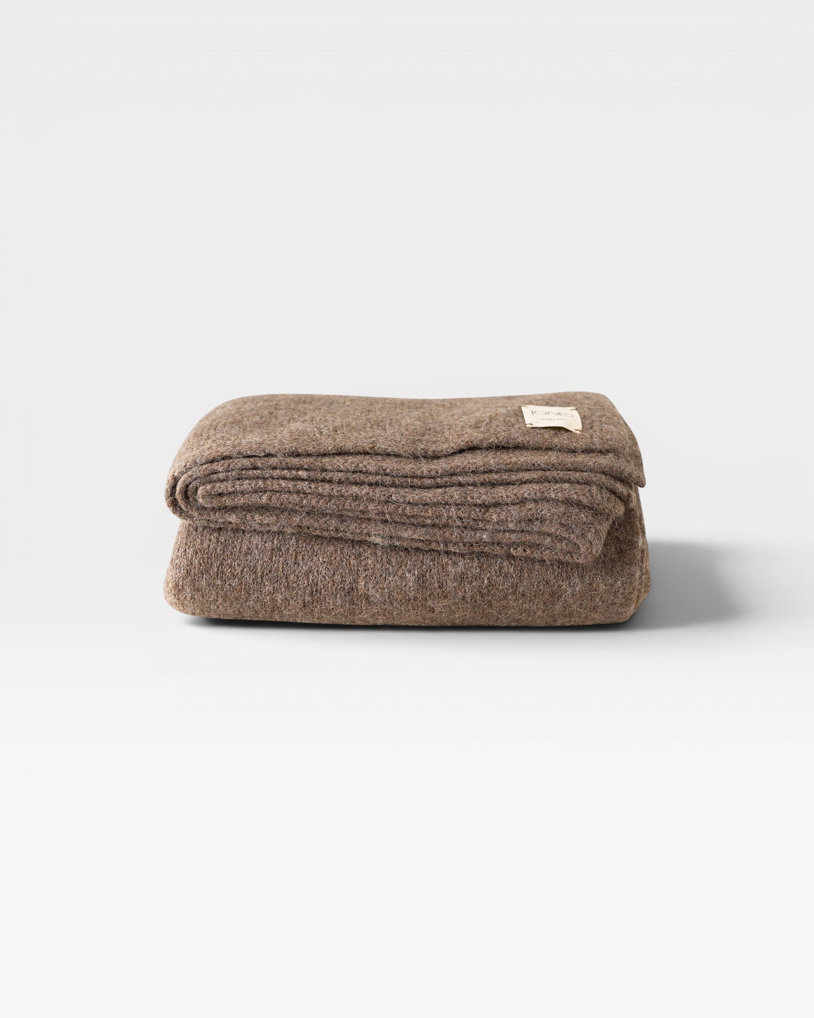 JONES + CO Jones Blanket in bark, a medium-weight alpaca wool blend throw with a soft texture.