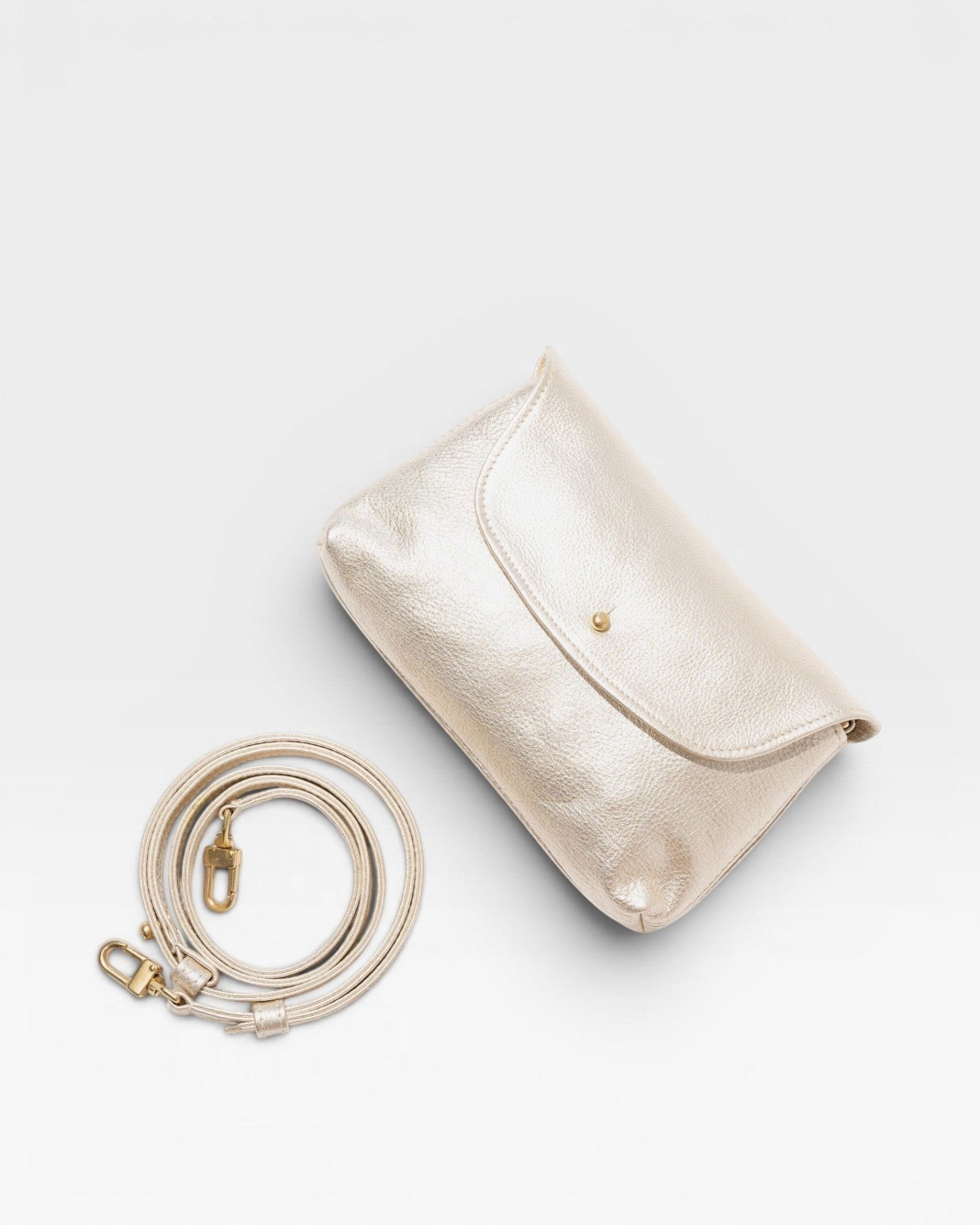 JONES + CO Kaanapali crossbody bag in champagne metallic aniline leather with a detachable strap.