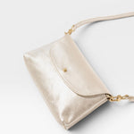 JONES + CO Kaanapali crossbody bag in champagne metallic aniline leather with gold hardware. Perfect for day or night.