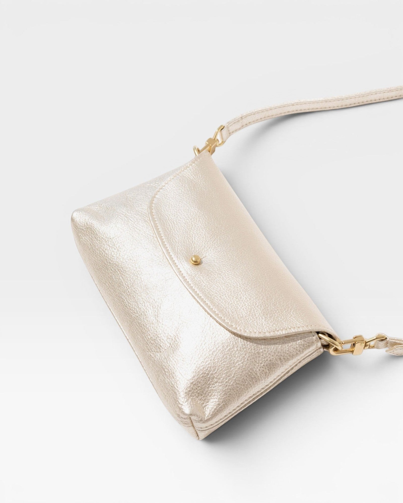 JONES + CO Kaanapali crossbody bag in champagne metallic aniline leather with gold hardware. Perfect for day or night.