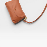 JONES + CO Kaanapali crossbody bag in maple pebble leather with gold-tone hardware and adjustable strap.