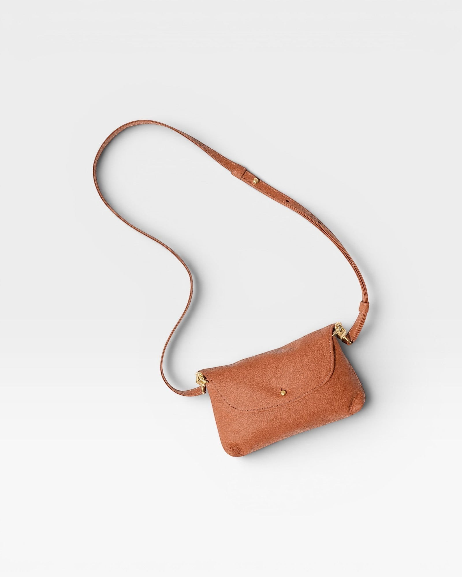 JONES + CO Kaanapali crossbody bag in maple pebble leather with gold hardware and adjustable strap.