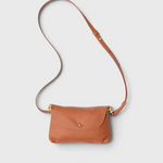 JONES + CO Kaanapali crossbody bag in maple pebble leather with a slim adjustable strap and gold hardware.