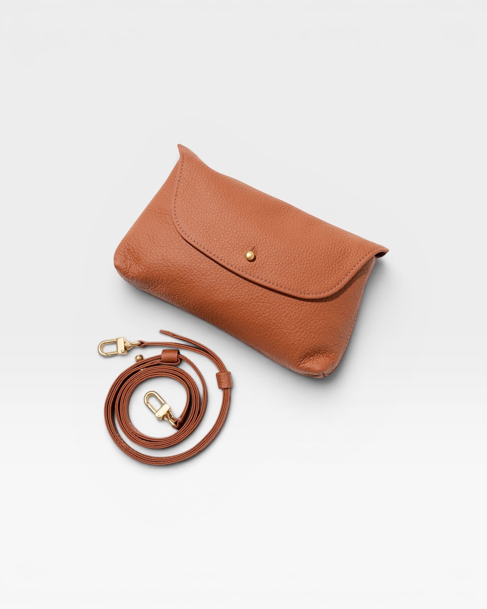 JONES + CO Kaanapali crossbody bag in maple pebble leather with gold snap closure and adjustable strap.