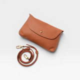 JONES + CO Kaanapali crossbody bag in maple pebble leather with gold snap closure and adjustable strap.