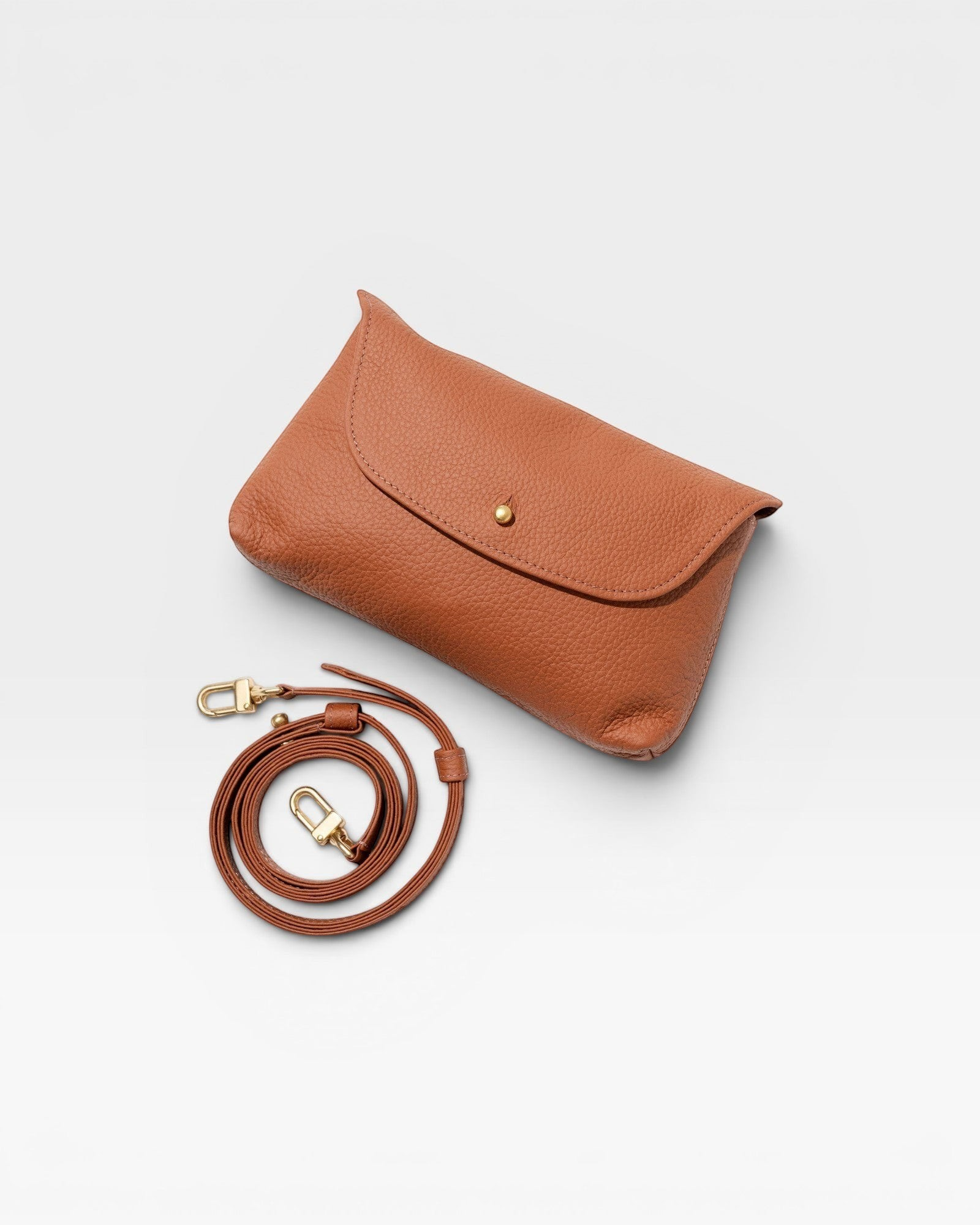 JONES + CO Kaanapali crossbody bag in maple pebble leather with gold snap closure and adjustable strap.