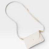 JONES + CO Kaanapali crossbody bag in milk pebble leather with gold hardware and adjustable strap.