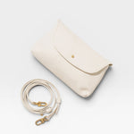 JONES + CO Kaanapali Crossbody in milk pebble leather with gold hardware and detachable strap.