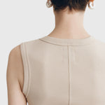 Back view of JONES + CO Kana Tank in dune beige, featuring a finely ribbed knit fabric and clean vertical seam detail.