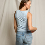 JONES + CO Khara U neck tank top in powder blue soft cotton worn by a woman, back view showing bra-friendly fit