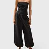 JONES + CO black Kortez balloon pants in viscose satin with an elasticated waist and hem on a model