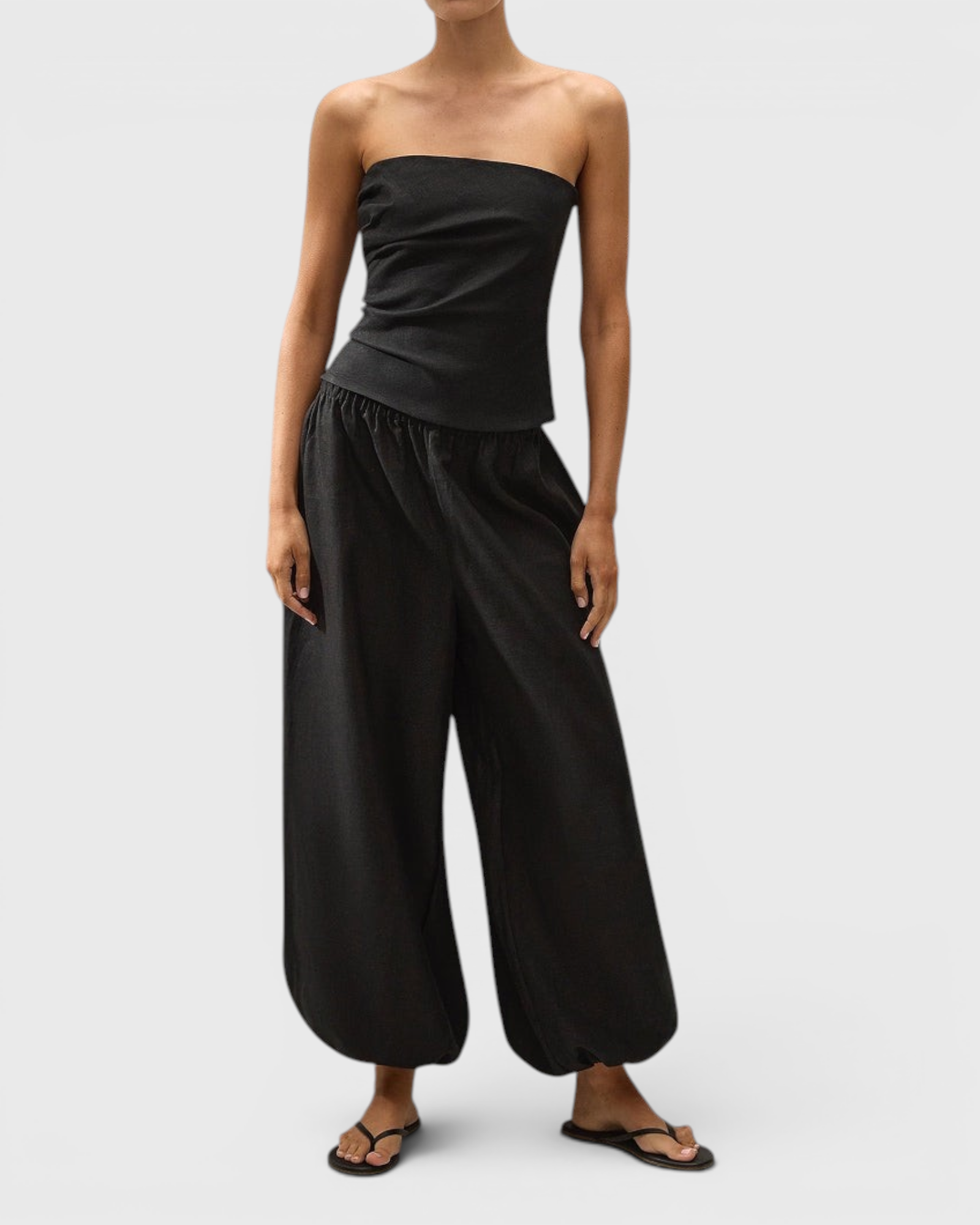 JONES + CO black Kortez balloon pants in viscose satin with an elasticated waist and hem on a model