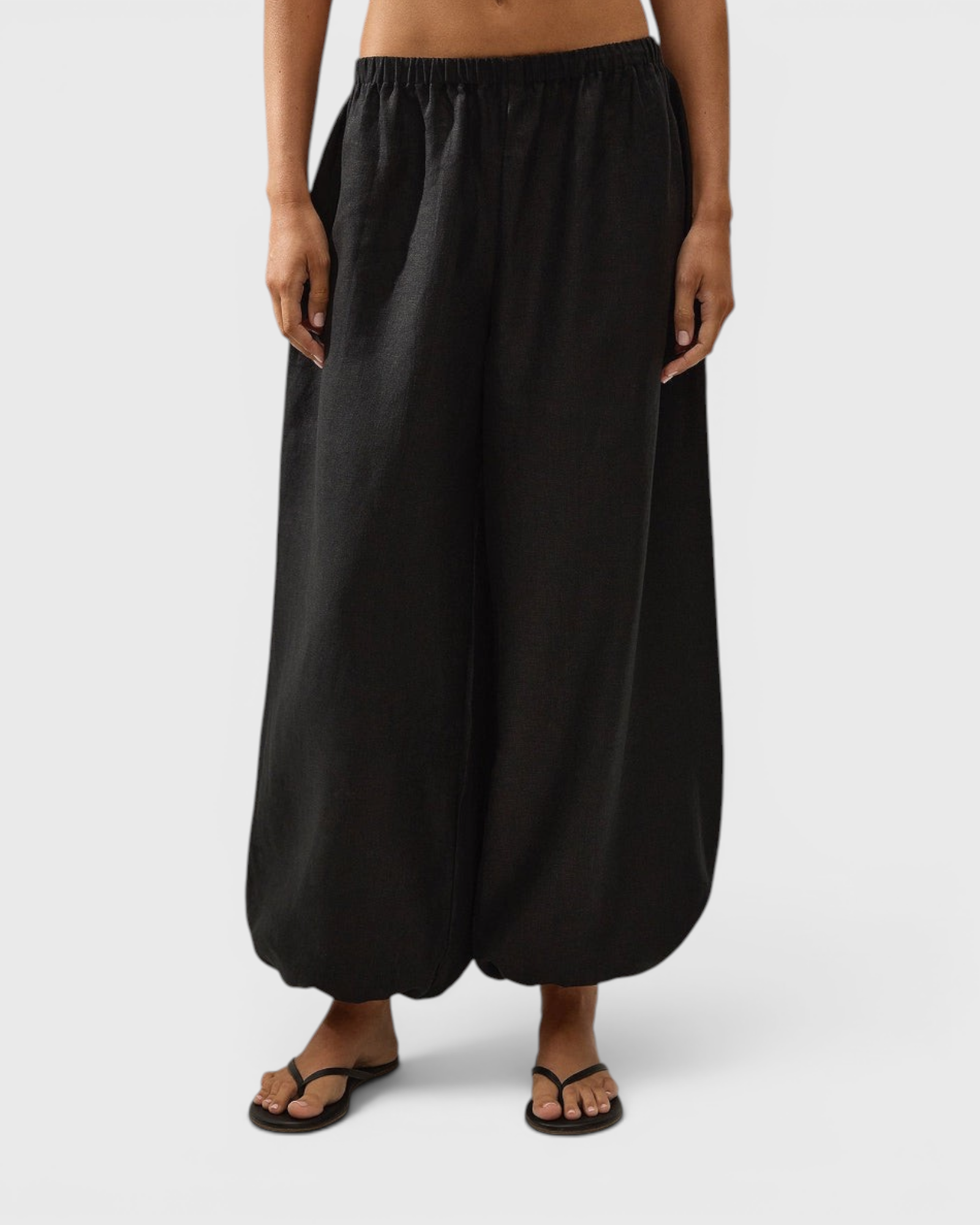 JONES + CO Kortez balloon pants in black viscose satin with an elasticated waist and hem on a model