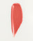 JONES + CO La Laque Tinted Lip Oil in a coral shade, a sheer, luminous, and hydrating lip gloss with a balm-like texture.