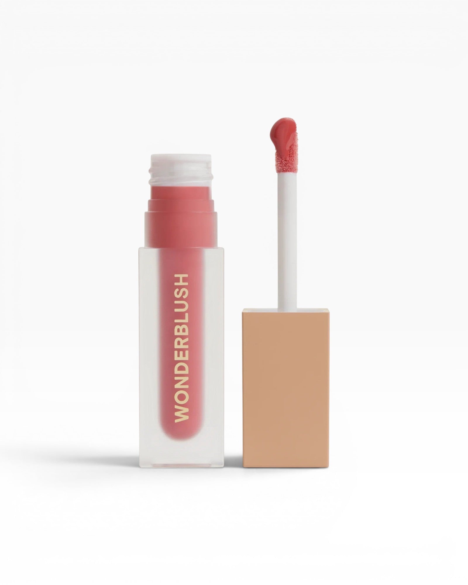 JONES + CO La Laque Tinted Lip Oil in a coral-pink shade, with a frosted glass bottle and gold lettering.