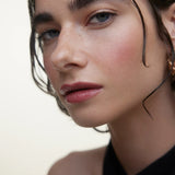 JONES + CO La Laque Tinted Lip Oil in a rosy shade, offering sheer luminous color and a balm-like finish on lips.