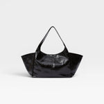 JONES + CO Large black patent leather tote bag with fixed shoulder strap and magnetic closure.