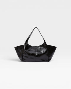JONES + CO Large black patent leather tote bag with fixed shoulder strap and magnetic closure.
