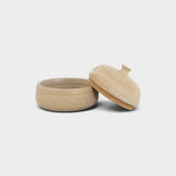 JONES + CO large handthrown ceramic jar in a natural beige finish with a matching lid on a plain background