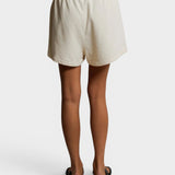 JONES + CO Layla French Terry lounge shorts in bright ivory with an elastic waistband and raw edge hem, back view.