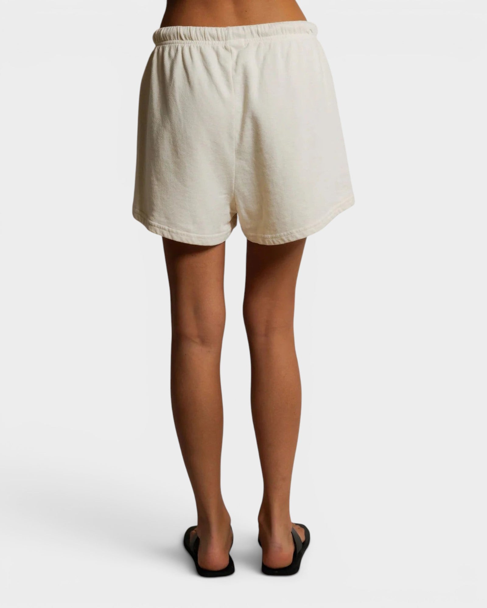 JONES + CO Layla French Terry lounge shorts in bright ivory with an elastic waistband and raw edge hem, back view.