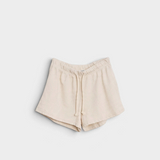 JONES + CO Layla French Terry sweat shorts in sugar beige with an elastic waistband, drawcord, and raw edge hem.