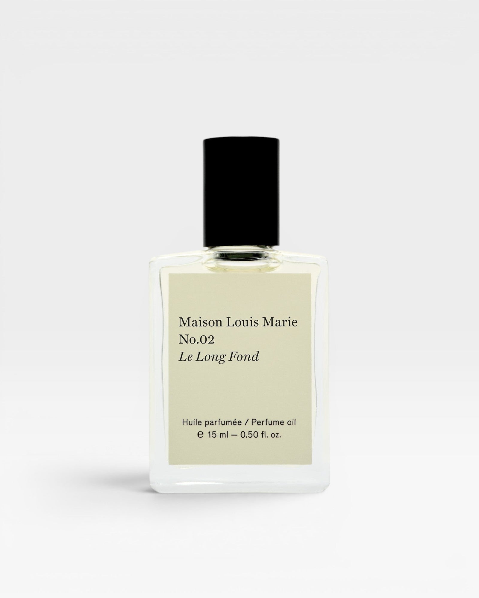 JONES + CO No.02 Le Long Fond perfume oil in a clear glass bottle with a black cap. Notes of hinoki wood, cedarwood, patchouli, and musk.