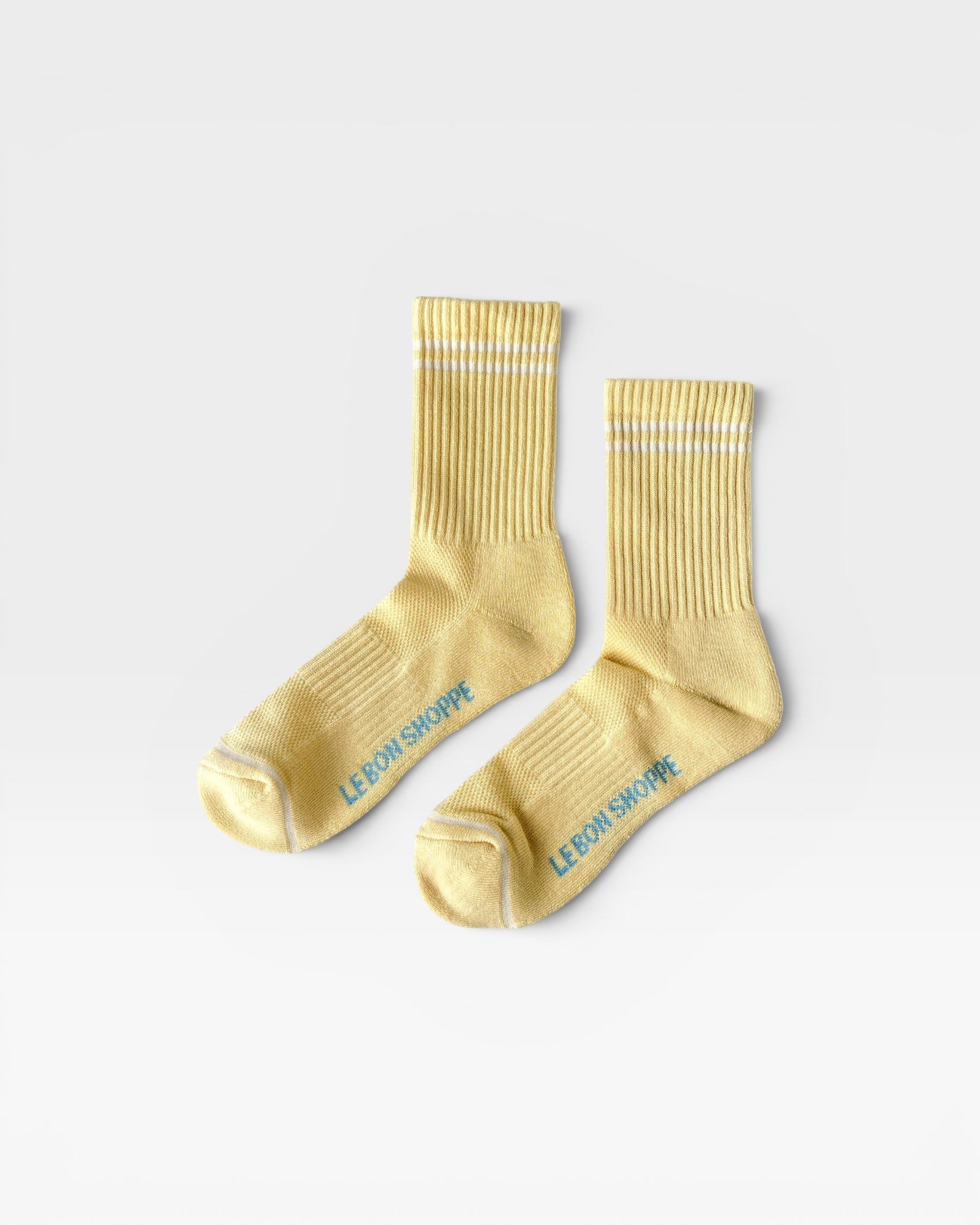 JONES + CO Boyfriend Socks in lemonade yellow with white double stripes and breathable mesh detailing.