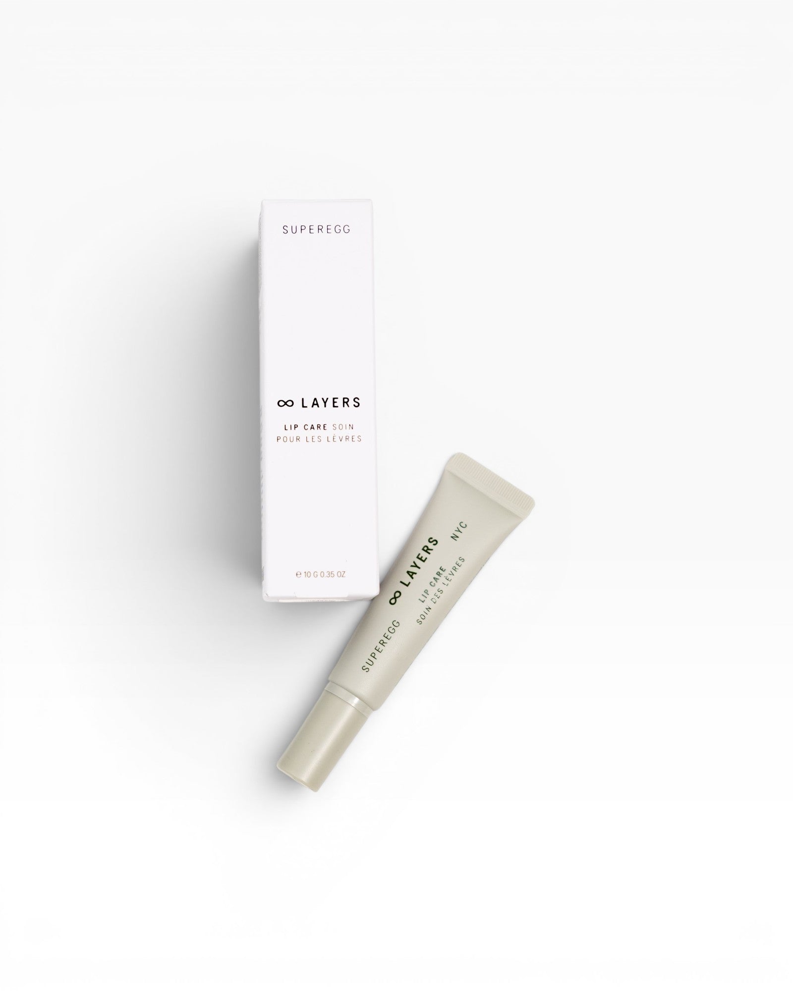 JONES + CO white box and light beige lip care tube with text "∞ LAYERS LIP CARE SOIN POUR LES LEVRES"