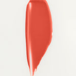 JONES + CO La Laque Tinted Lip Oil in a coral shade, a glossy balm with sheer luminous color.