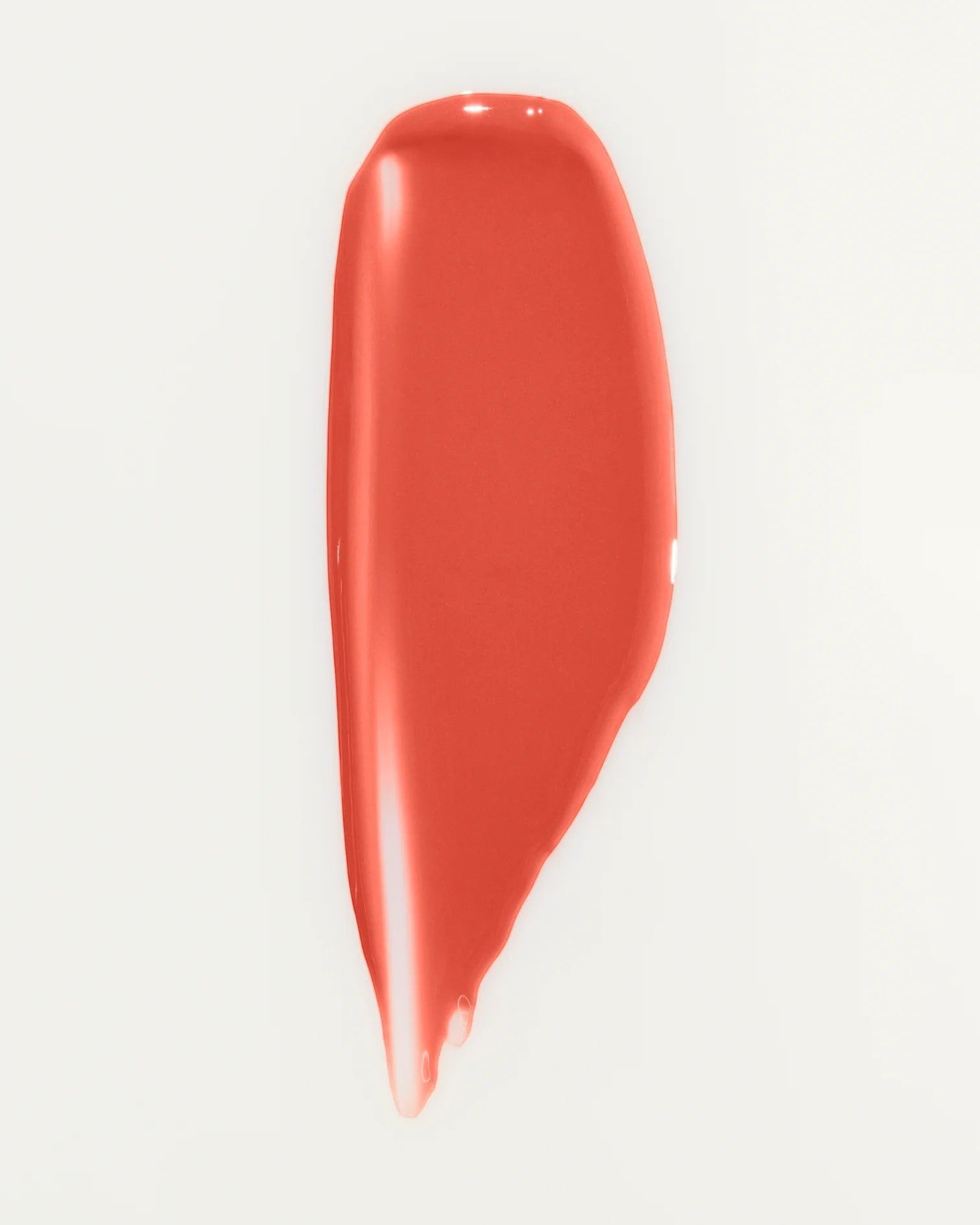 JONES + CO La Laque Tinted Lip Oil in a coral shade, a glossy balm with sheer luminous color.