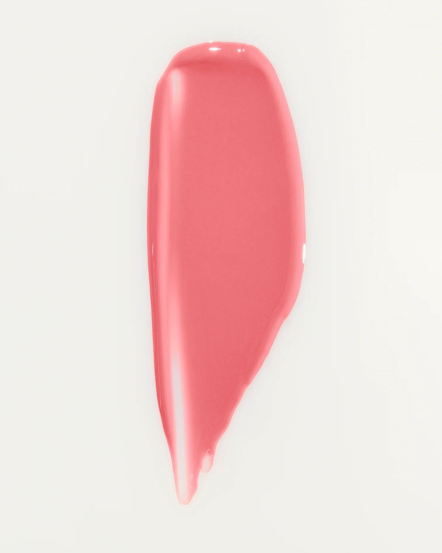 JONES + CO La Laque Tinted Lip Oil swatch in a sheer coral-pink shade. Lightweight, glossy finish.