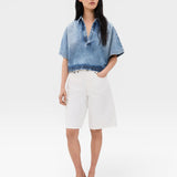 JONES + CO blue washed denim Lotus shirt with open collar and dolman sleeves, cropped fit.