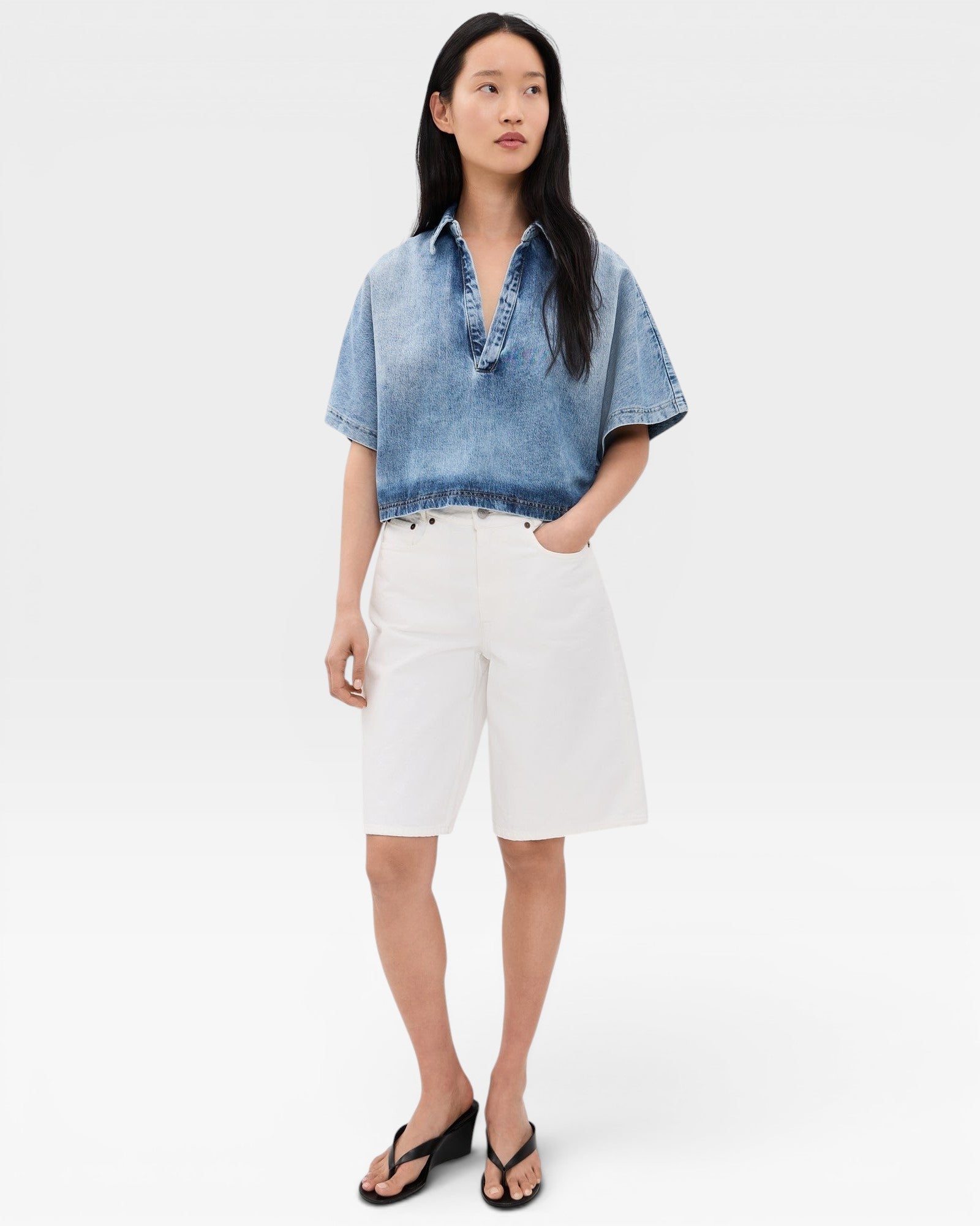 JONES + CO blue washed denim Lotus shirt with open collar and dolman sleeves, cropped fit.