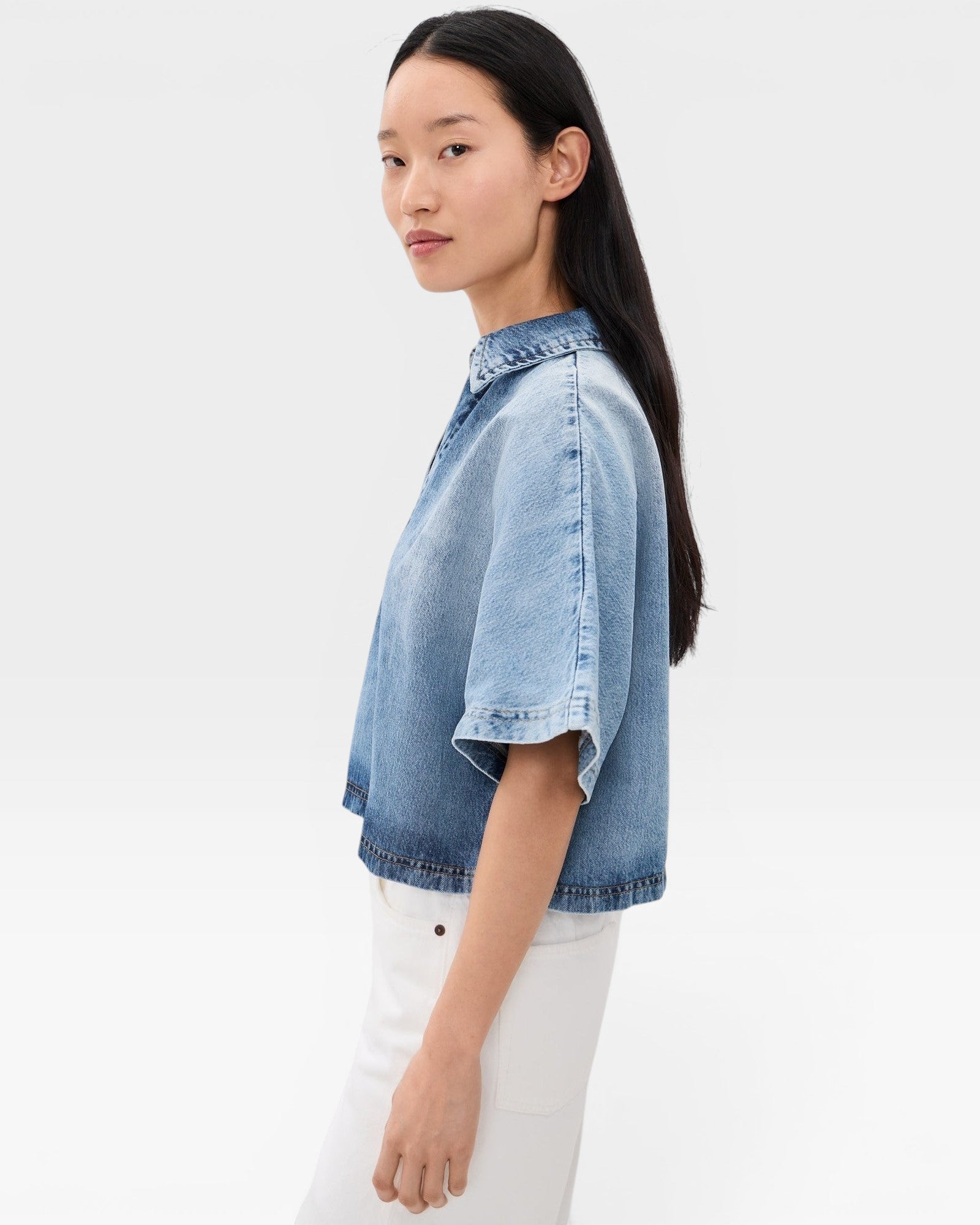 JONES + CO Lotus shirt in Malibu Wash denim, featuring an open collar and wide dolman sleeves. Relaxed fit, cropped length.