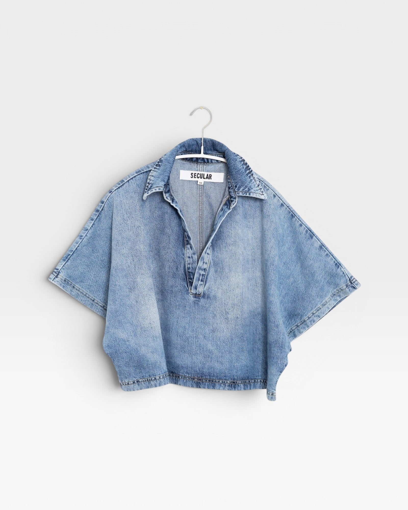JONES + CO Lotus shirt in Malibu Wash light blue denim. Relaxed fit, cropped, open collar, wide dolman sleeves.