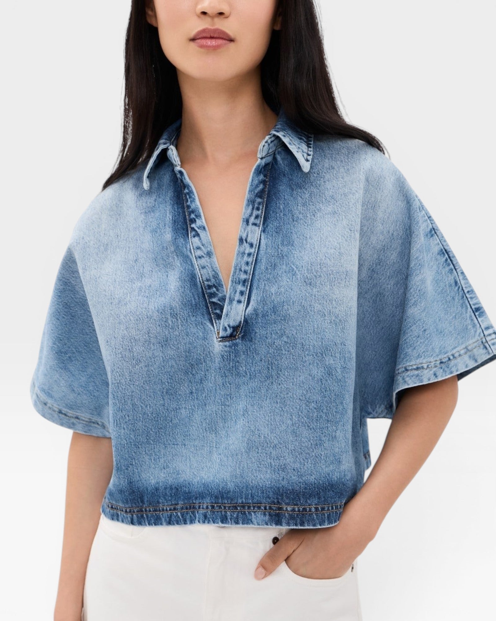JONES + CO Lotus shirt in Malibu Wash denim, featuring an open collar, dolman sleeves, and a cropped fit.