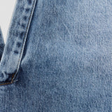 JONES + CO Lotus shirt in Malibu Wash blue denim, featuring an open collar and dolman sleeves.