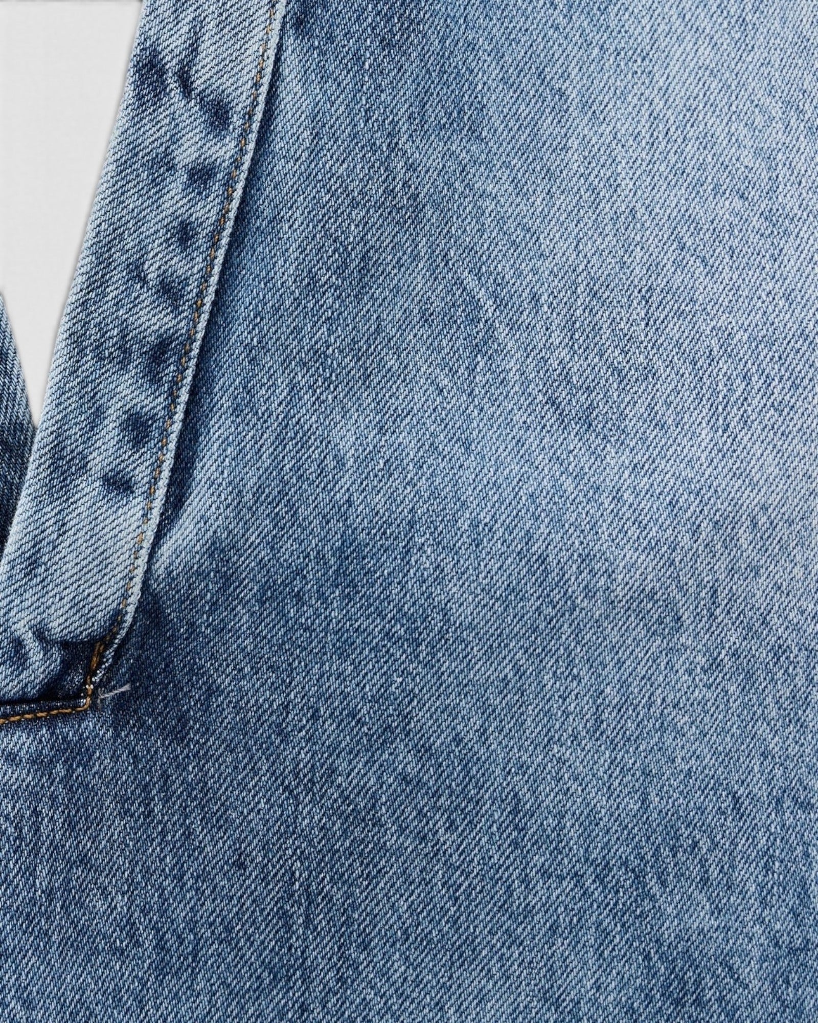 JONES + CO Lotus shirt in Malibu Wash blue denim, featuring an open collar and dolman sleeves.