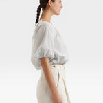 JONES + CO light blue cropped Lotus top with short sleeves, gathered cuffs, and French knot embroidery.