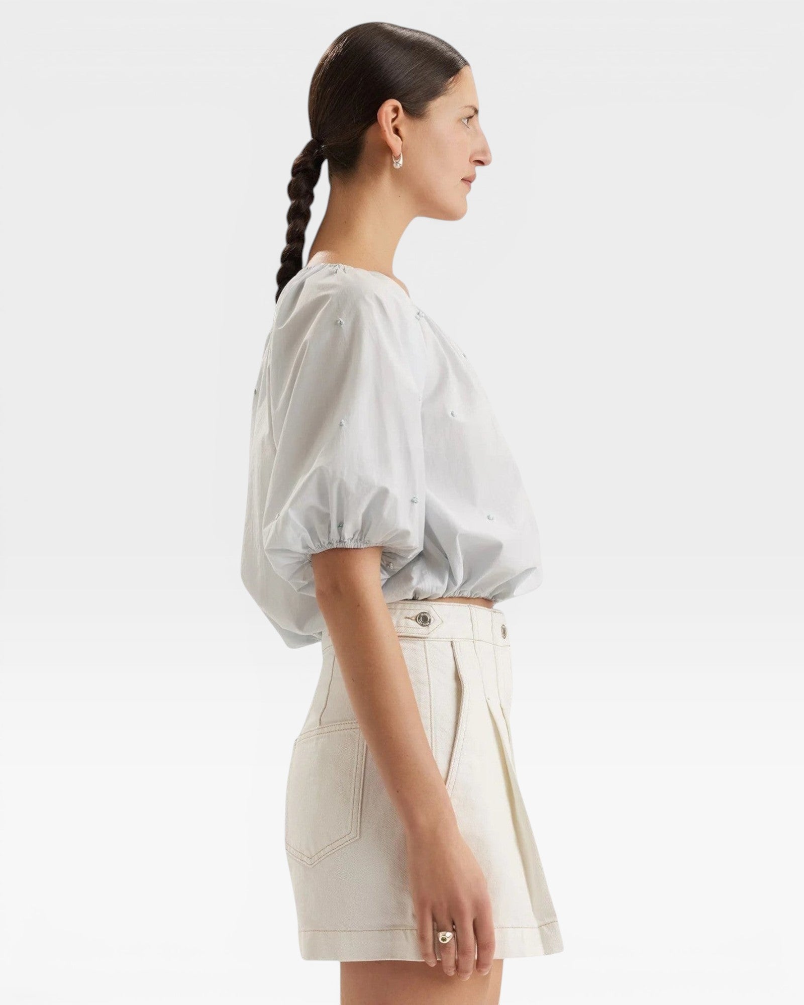 JONES + CO light blue cropped Lotus top with short sleeves, gathered cuffs, and French knot embroidery.
