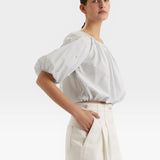 JONES + CO light blue cropped blouse with short sleeves, gathered cuffs, and French knot embroidery.
